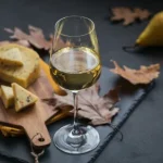a-glass-of-white-wine-served-with-cheese-in-a-cutt-2022-01-19-00-00-15-utc-scaled_sthumb.webp